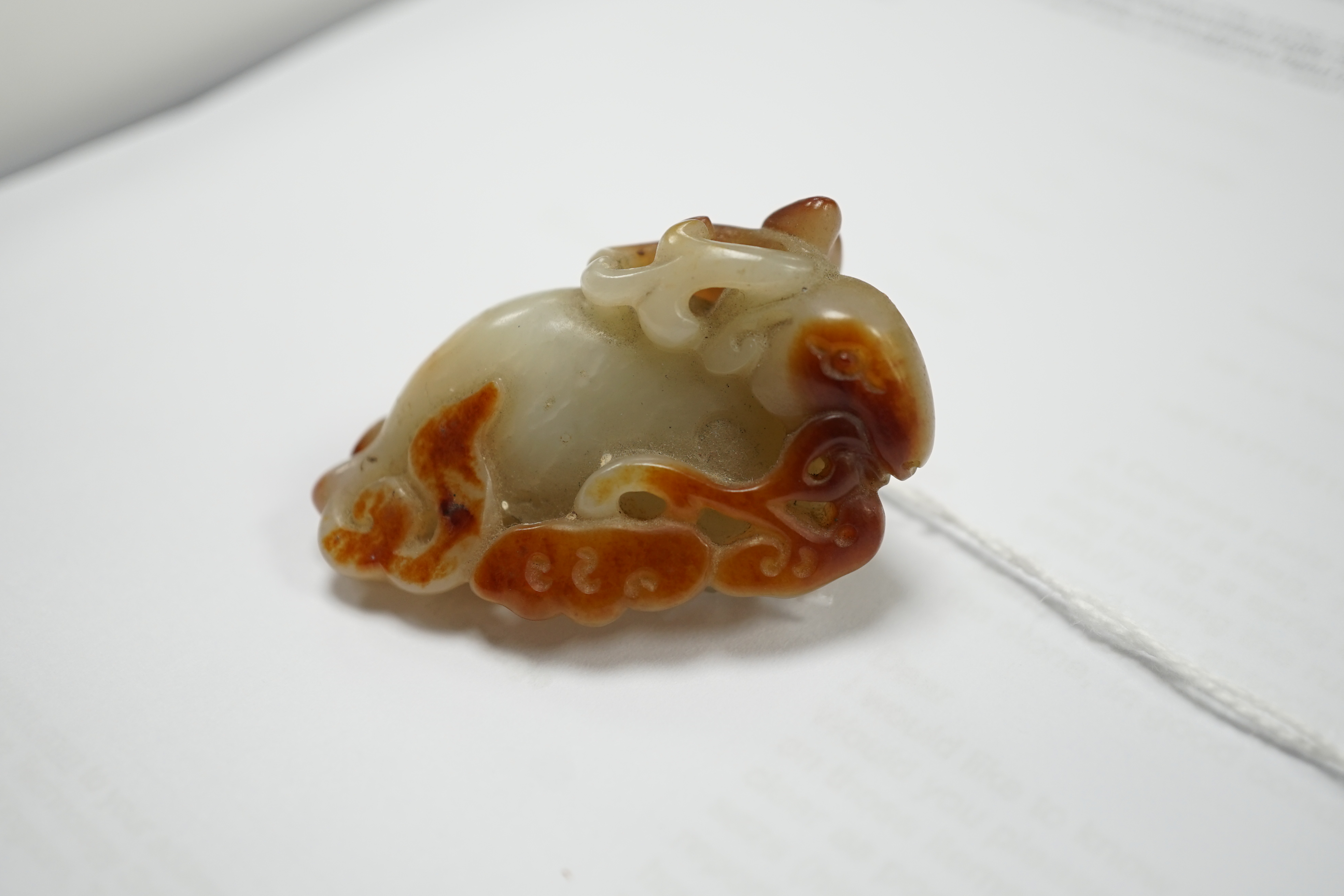 A Chinese pale celadon and russet skin jade figure of a stag, 19th century